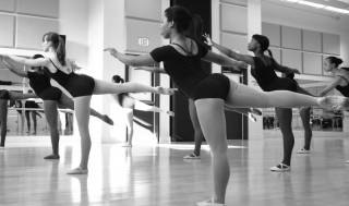 Dancers in the Giving Inspirational Feeling Through Expressive Dance Performing Ensemble balance gracefully on one foot.