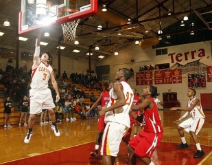 2010 CCHS graduate Taylor Layne aggressively drives to the basket and finishes with a right-handed layup against Winder-Barrow High School on Feb. 2, 2010 at CCHS. Layne was the only White American on the 2010 CCHS basketball team. He was named the team's Co-MVP his senior season alongside teammate Babatunde Olumuyiwa. Photo Courtesy of Richard Hamm.